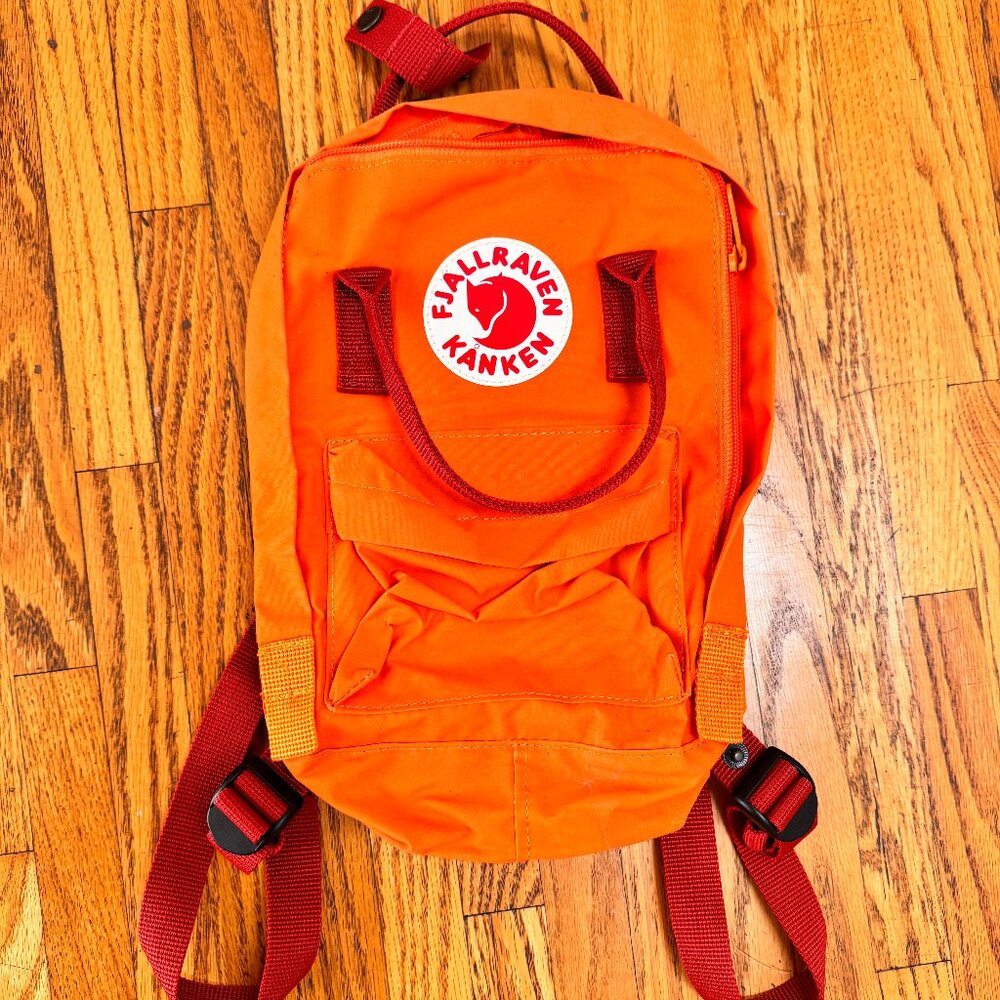 Mini Fjallraven Kanken orange backpack with red straps